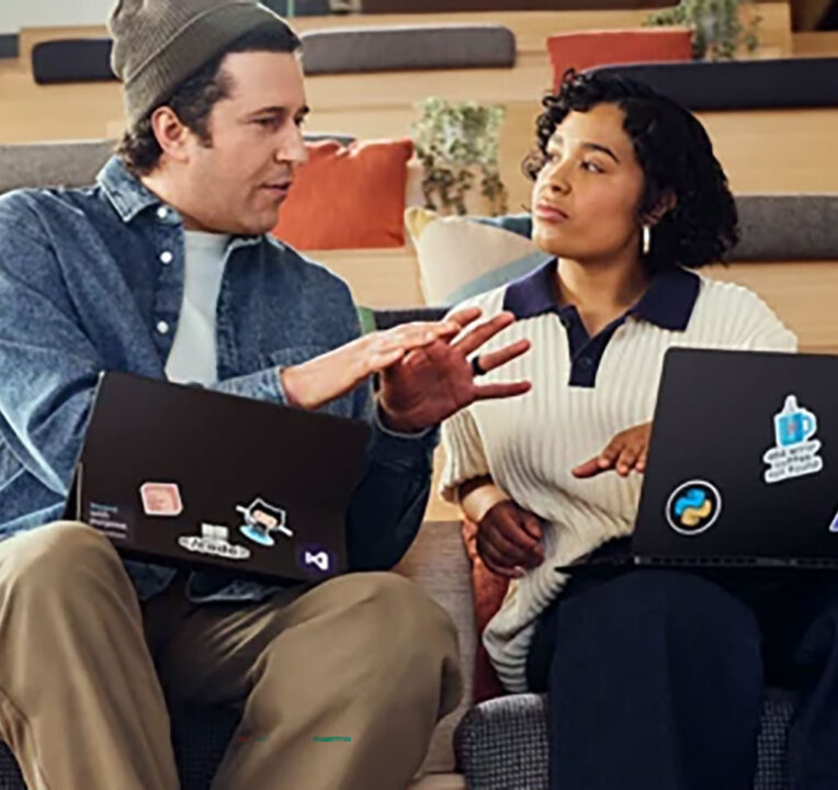 Two people seated having a discussion.